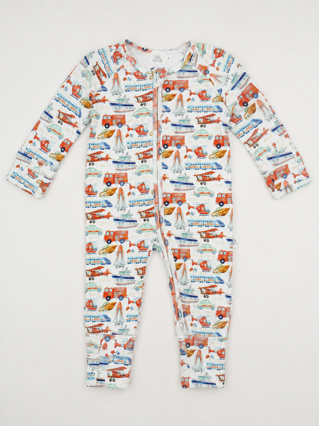 A long-sleeve baby growsuit with an all-over colourful print of fire trucks, airoplanes, and cars on a white background. Made from 100% GOTS Organic Cotton