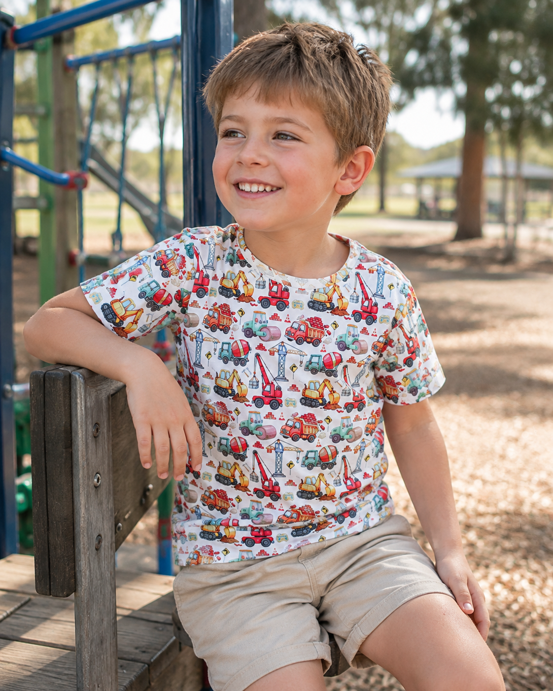 Boy wearing the Little Acres Co 100% GOTS organic cotton Construction T-shirt at the playground. Perfect for everyday wear, daycare, preschool and more. 