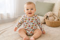 Baby wearing Little Acres Co construction print organic cotton long sleeve bodysuit