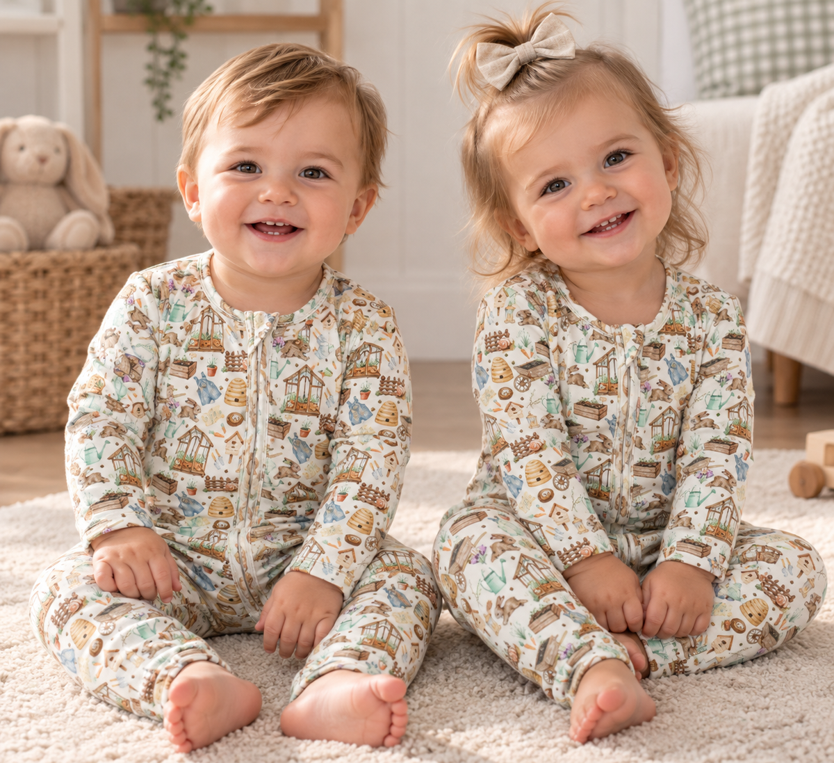 Baby boy and girl wearing Little Acres Co garden print organic cotton growsuit