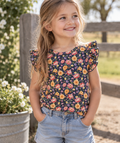 Girl wearing Little Acres Co navy floral organic cotton t-shirt